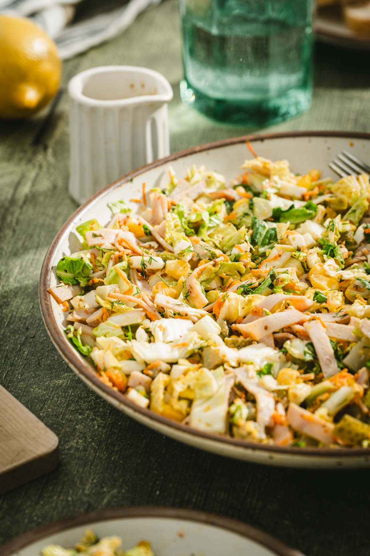 side view of a bowl with salad, dish with dressing