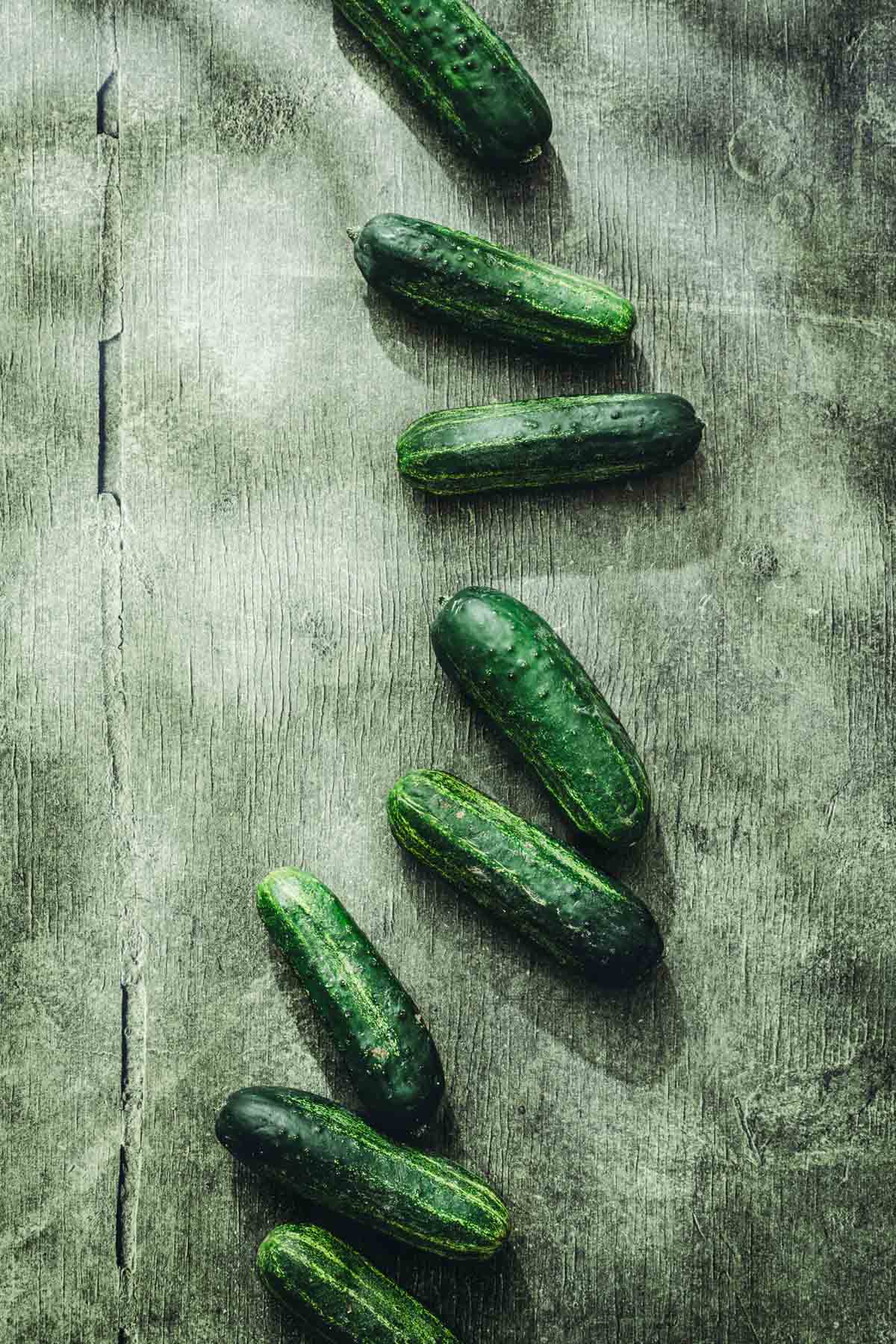 various ground cucumbers arranged on a green backdrop