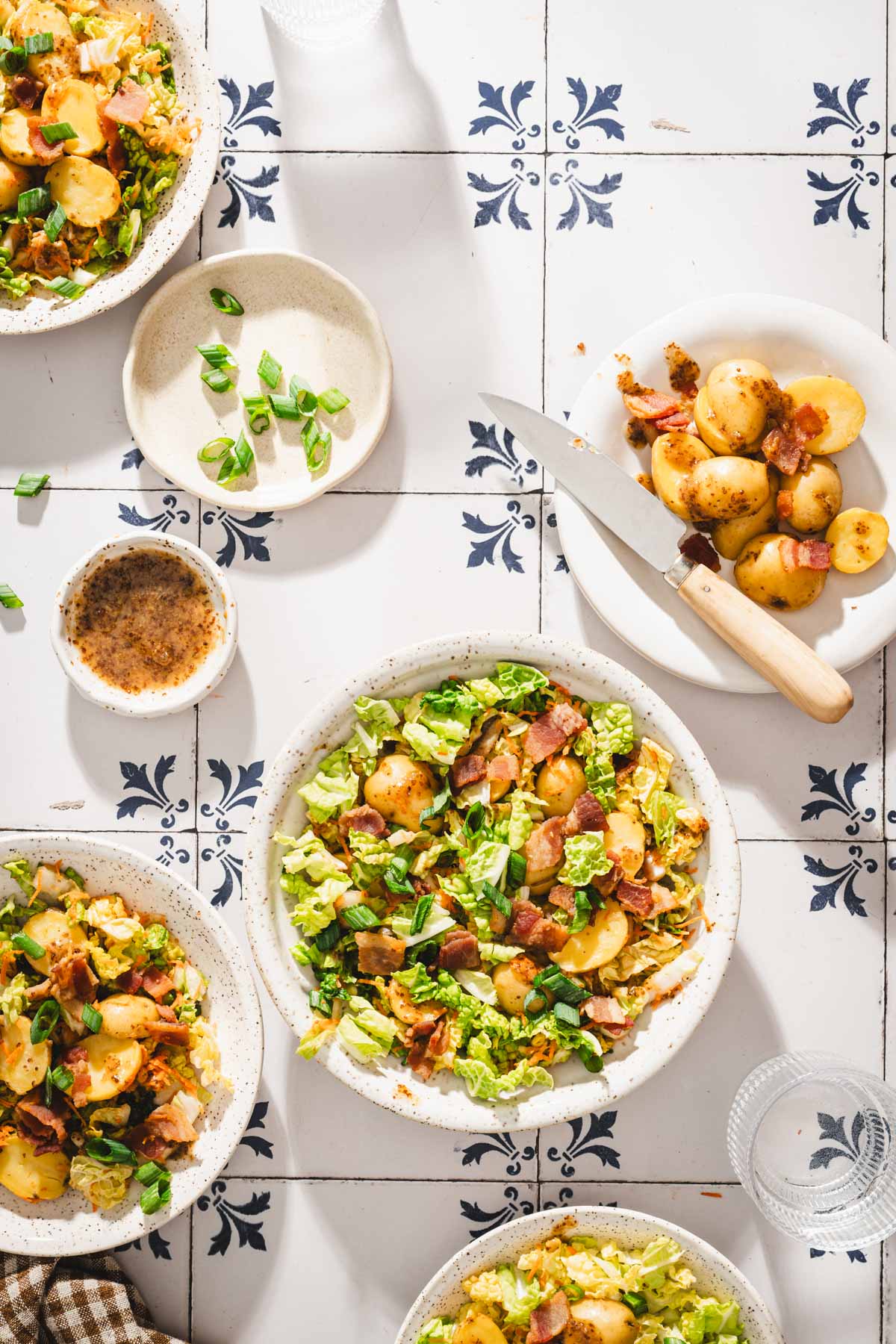 various serving dishes with napa salad