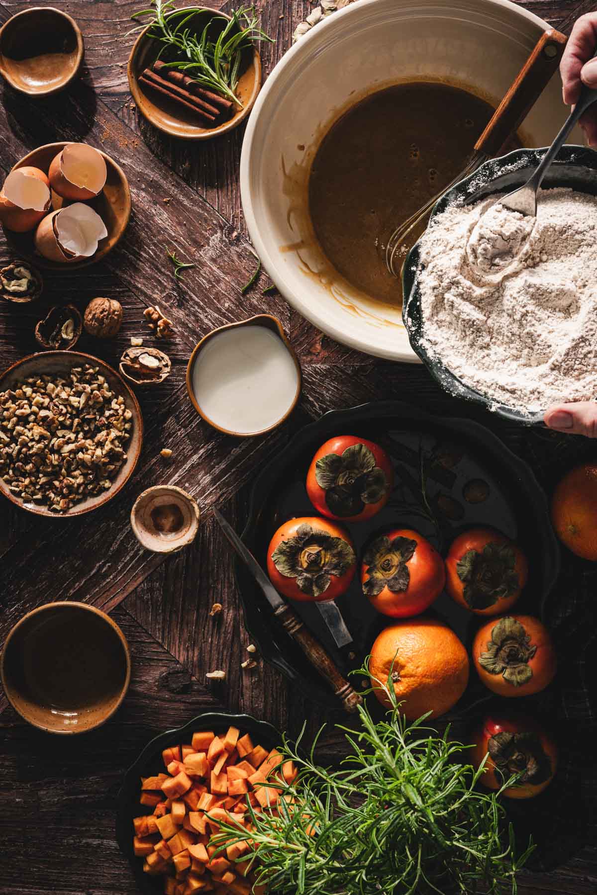 hands in frame adding flour to the wet ing