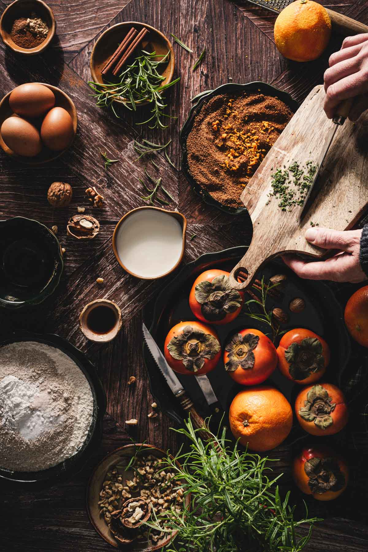hands in frame adding rosemary to coconut sugar