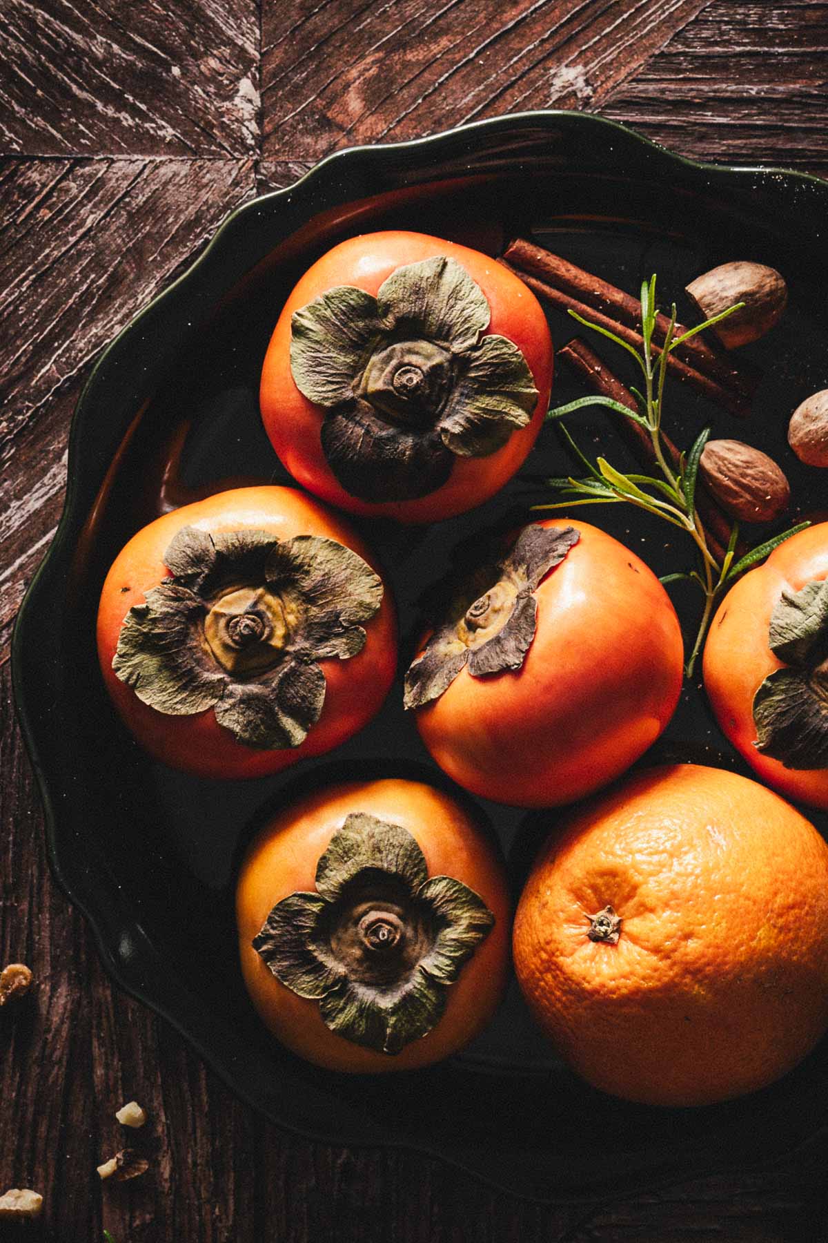 close up of paersimmons and oranges