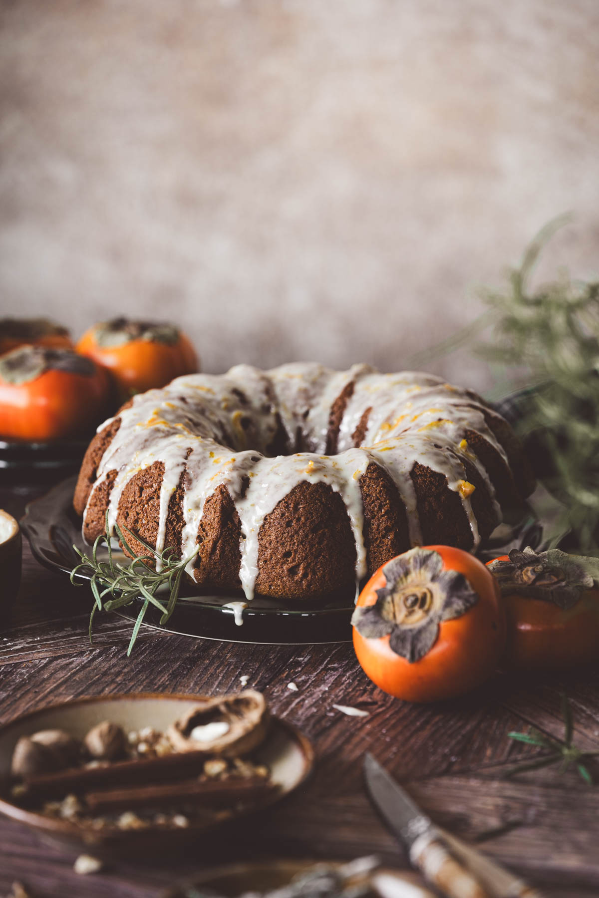cake ona serving plate, persimmons, other ing around