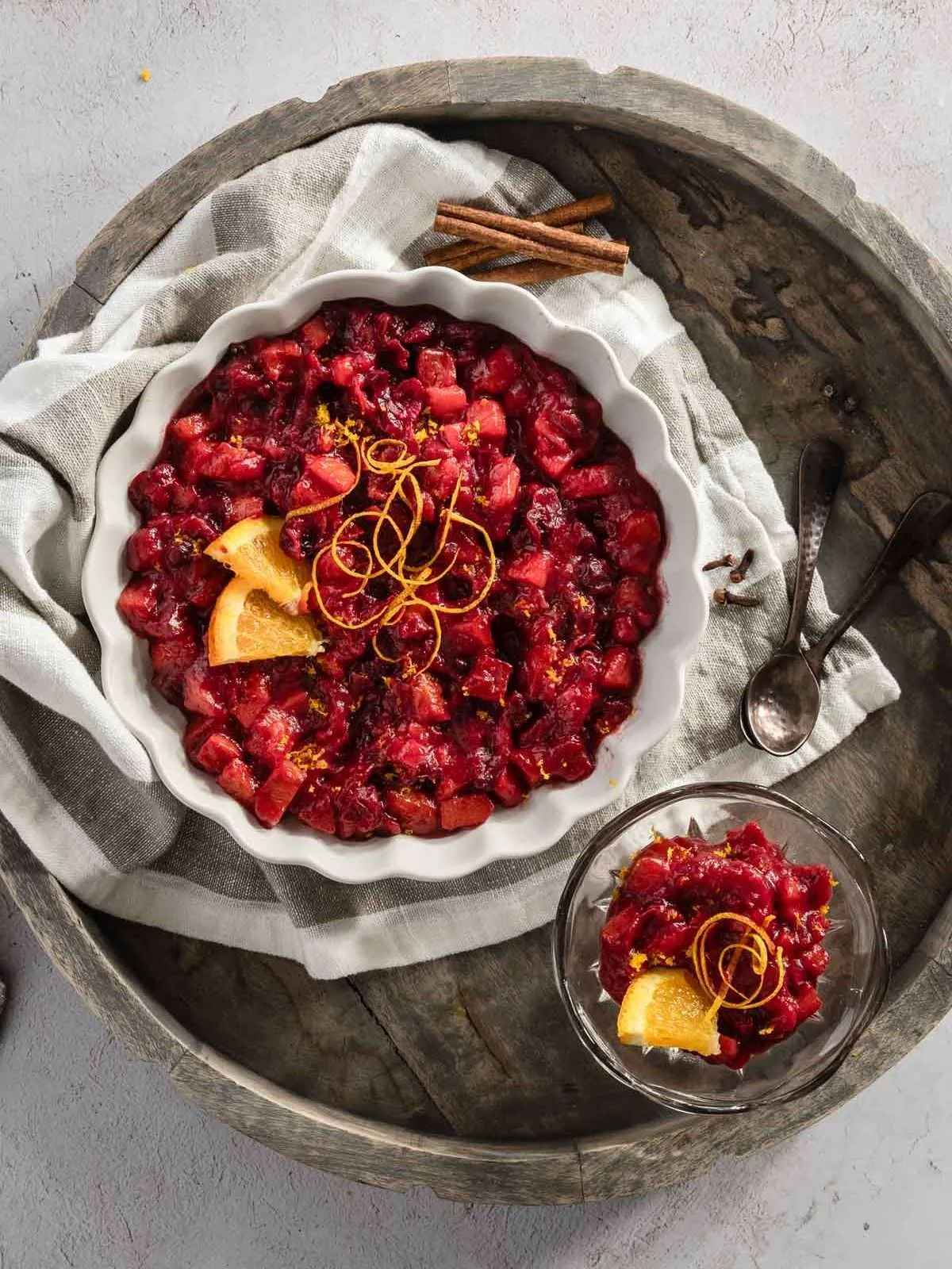 persimmon cranberry sauce in a bowl on a wooden serving tray