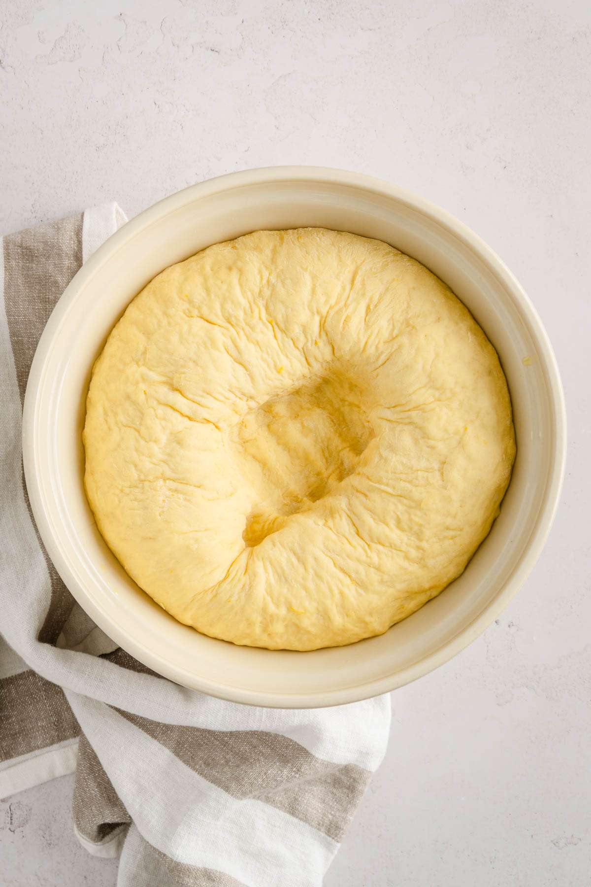 paczki dough in a bowl, deflated