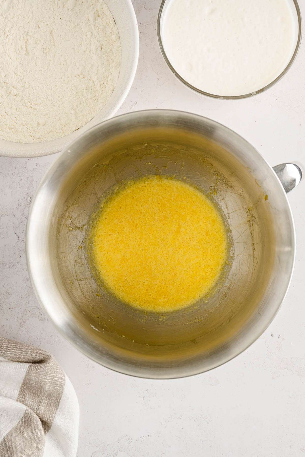 bowl with wet ingredients, another one with flour and one with the yeast mixture