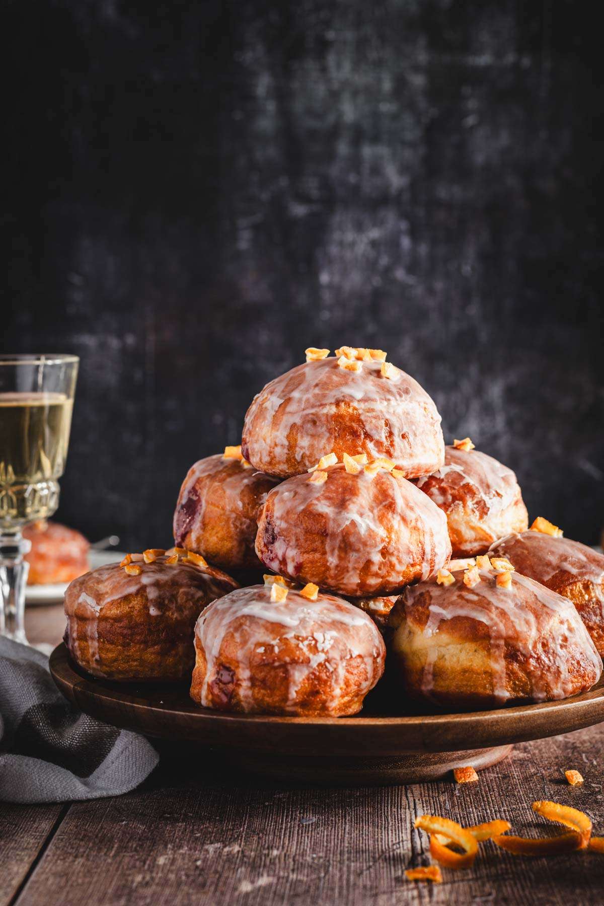 paczki arranged on a cake stand, glass with wine