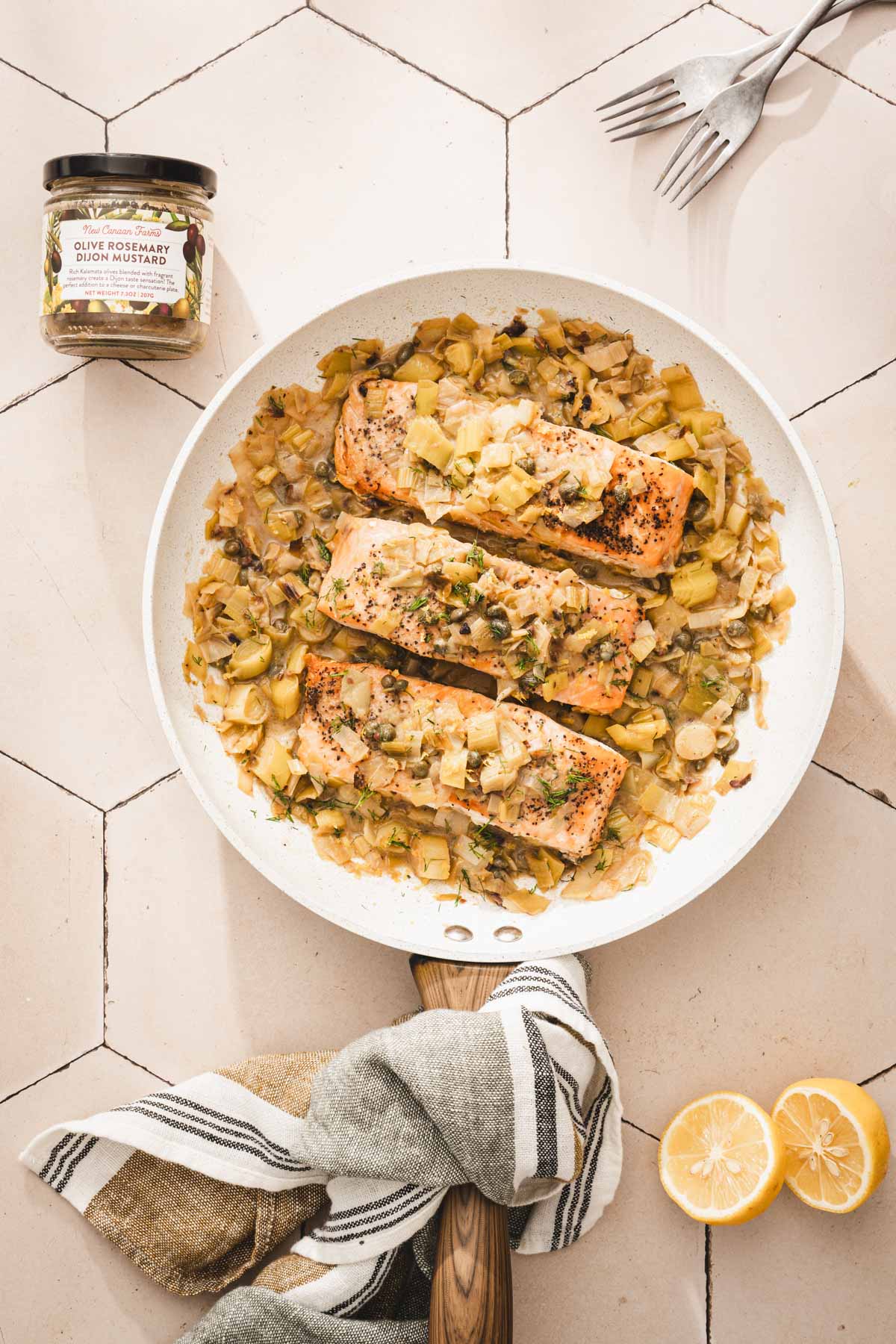 salmon in a skillet, jar with mustard