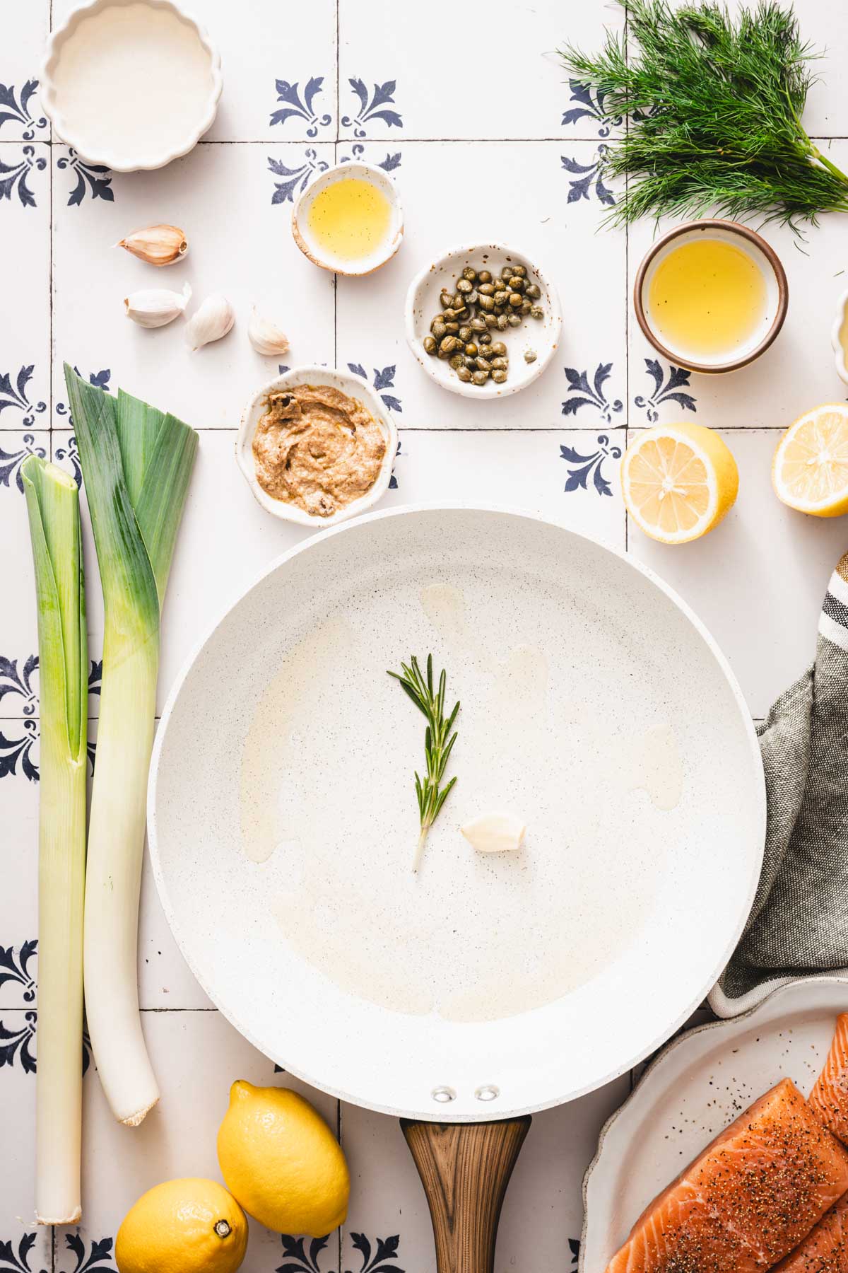 skillet with olive oil, rosemary and garlic