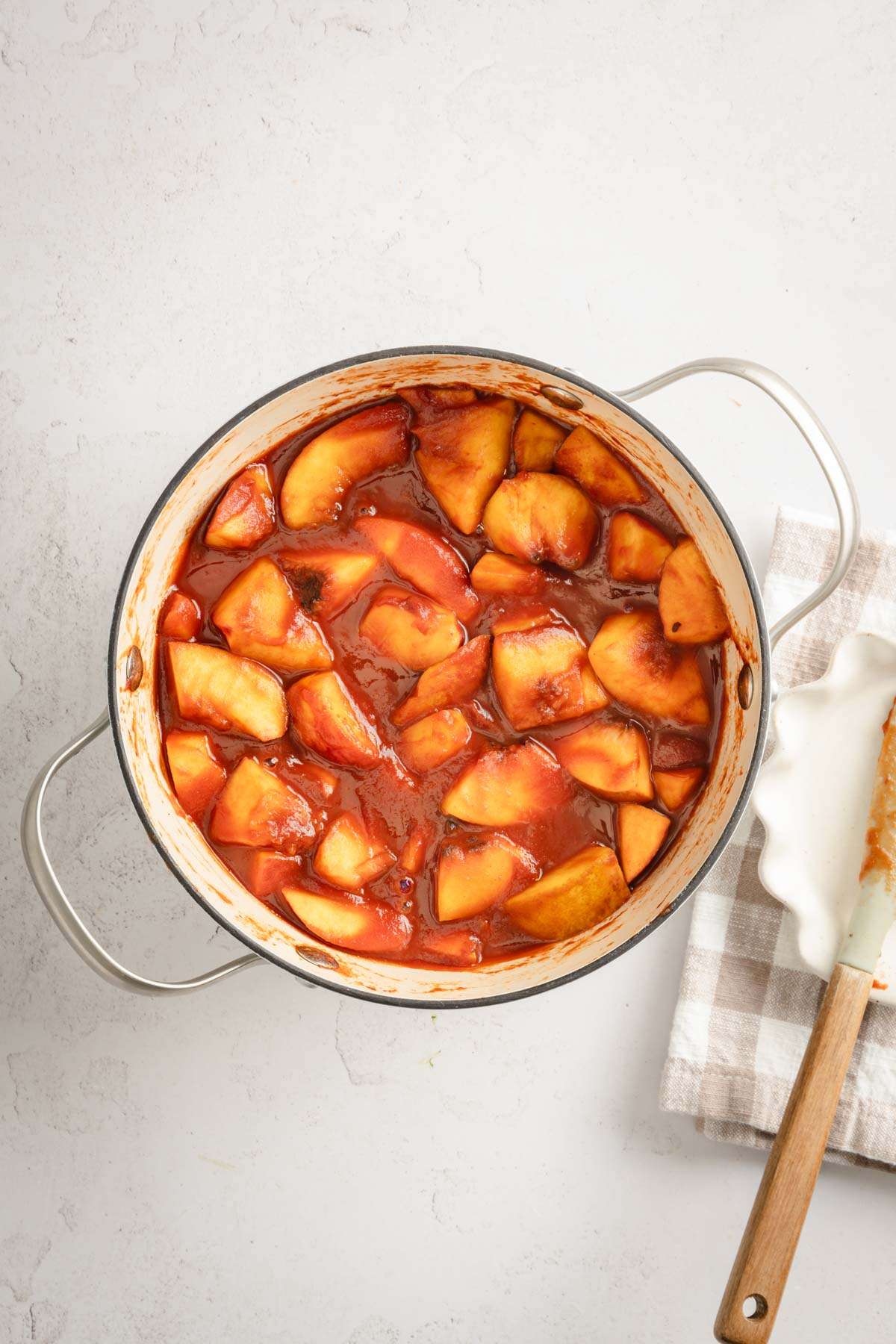 Chopped peaches in a cooking pan mixed with all the ingredients