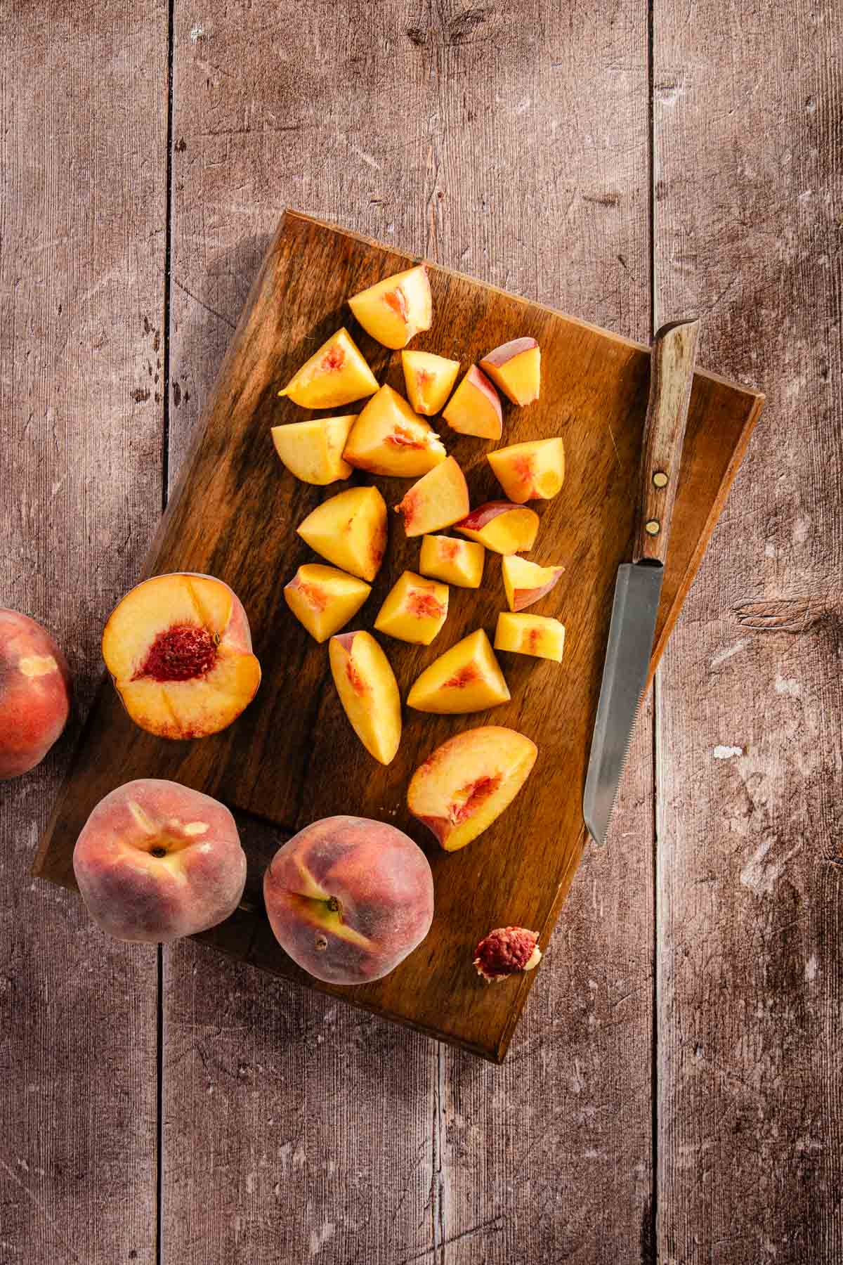 Fresh peaches on a cutting board, small knife