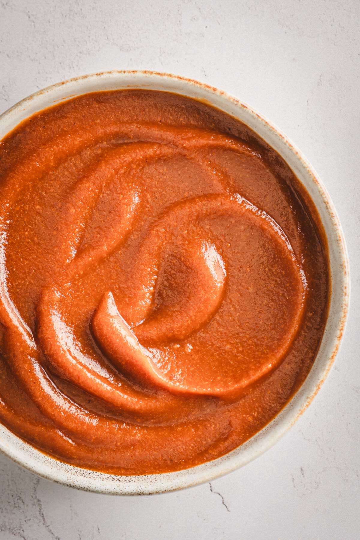 Peach BBQ Sauce in a serving bowl, close up