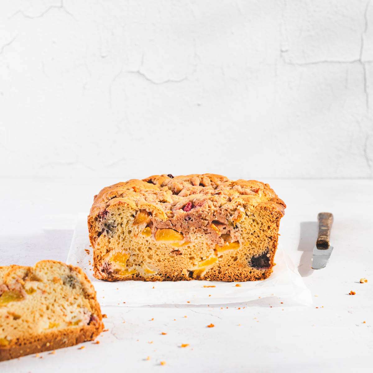 Peach bread, front look, one slice to the left, small knife