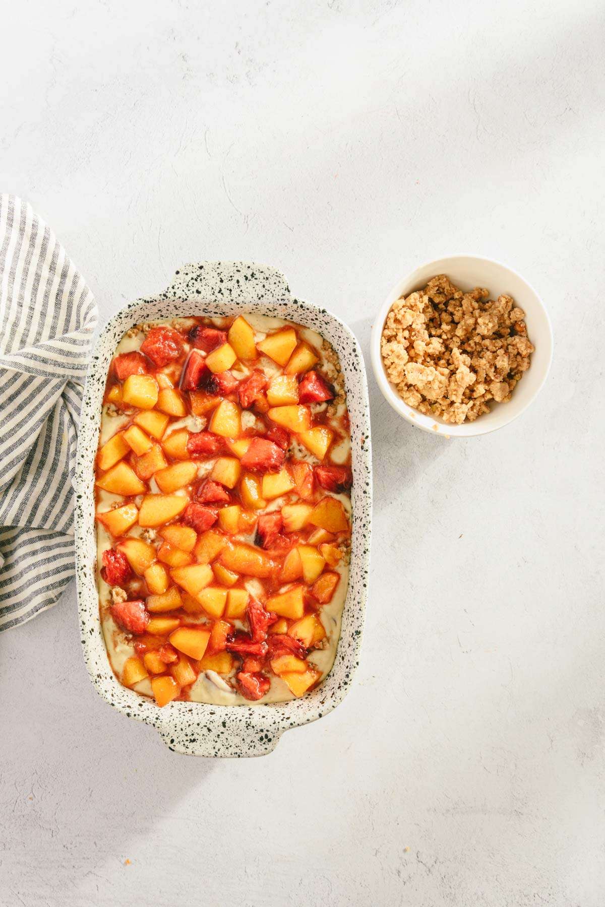 fresh peaches added on top of the batter, bowl with crumble