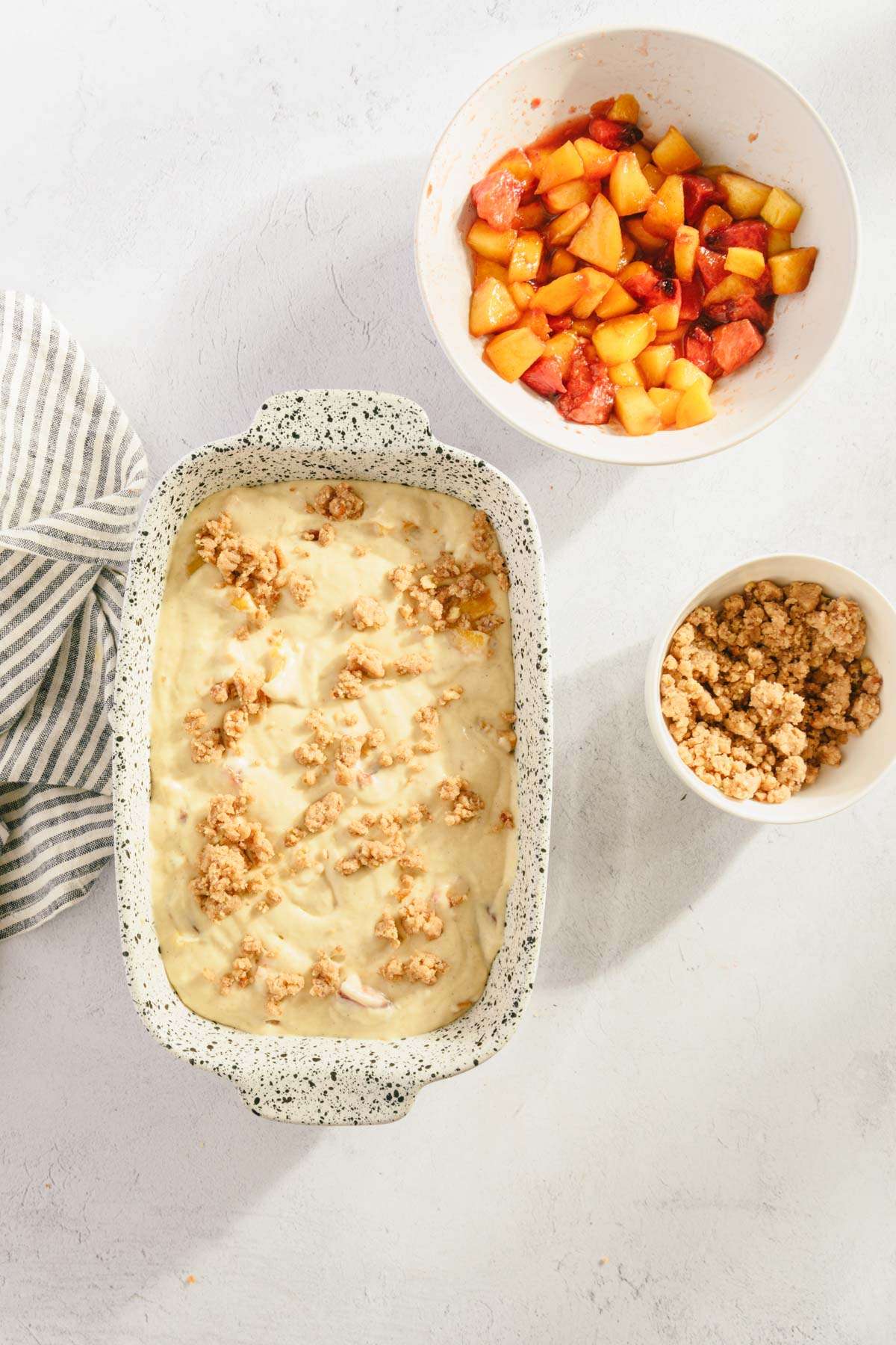 baking dish with batter and crumble added,