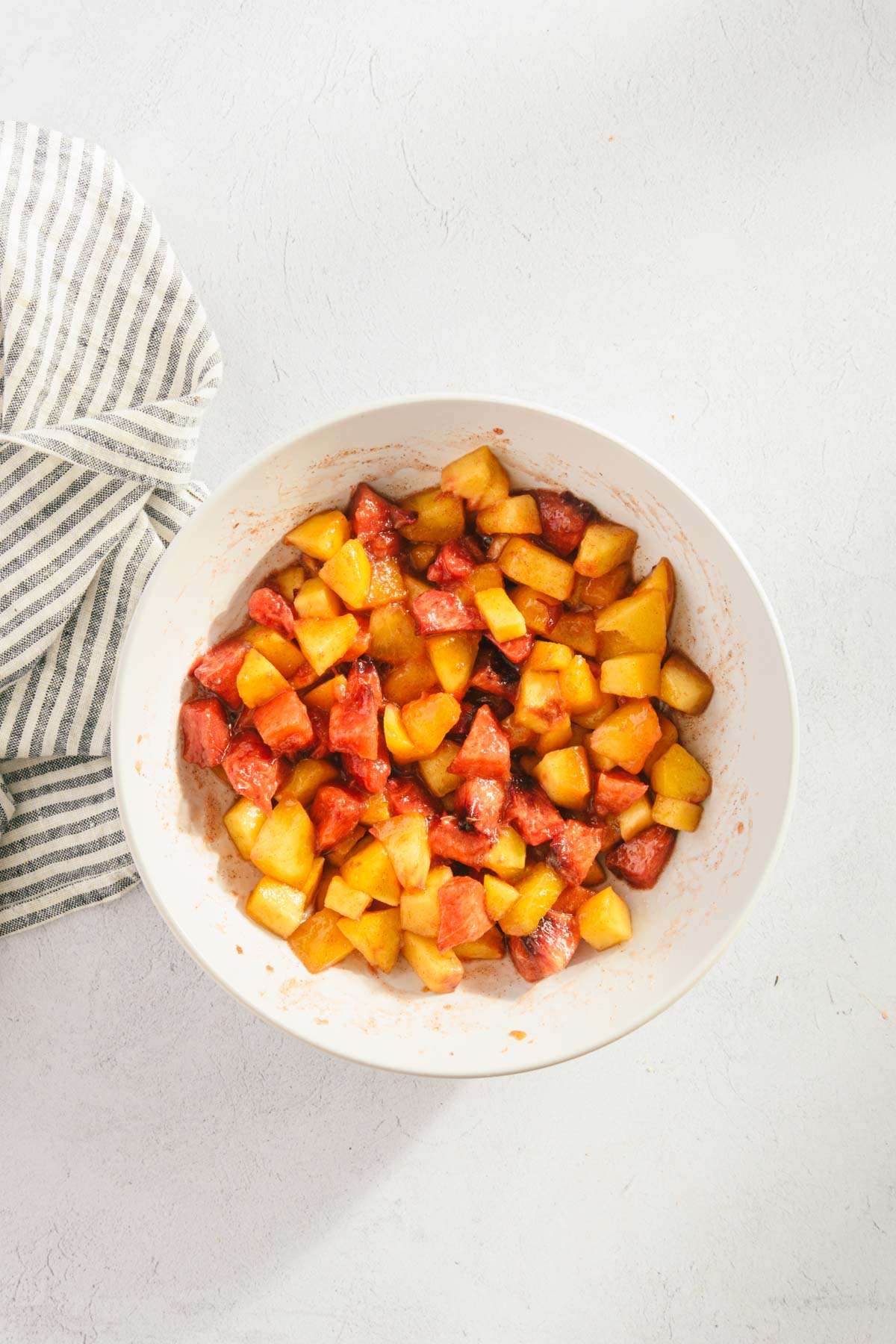 diced peaches mixed with cinnamon and sugar