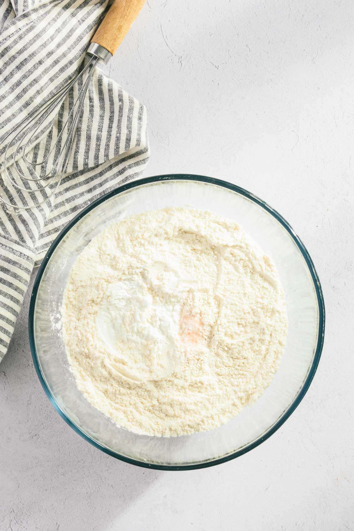 glass bowl with flour and salt and baking powder and soda mixed in