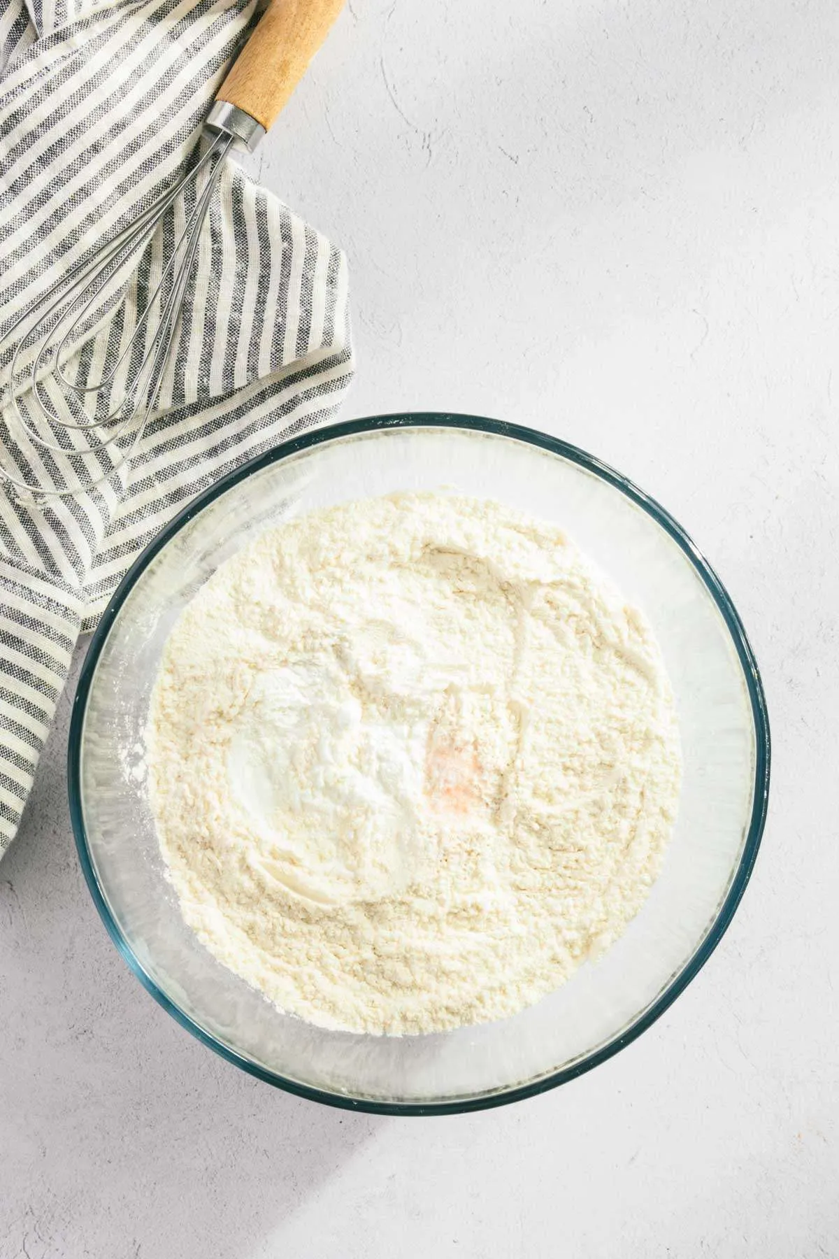 glass bowl with flour and salt and baking powder and soda mixed in