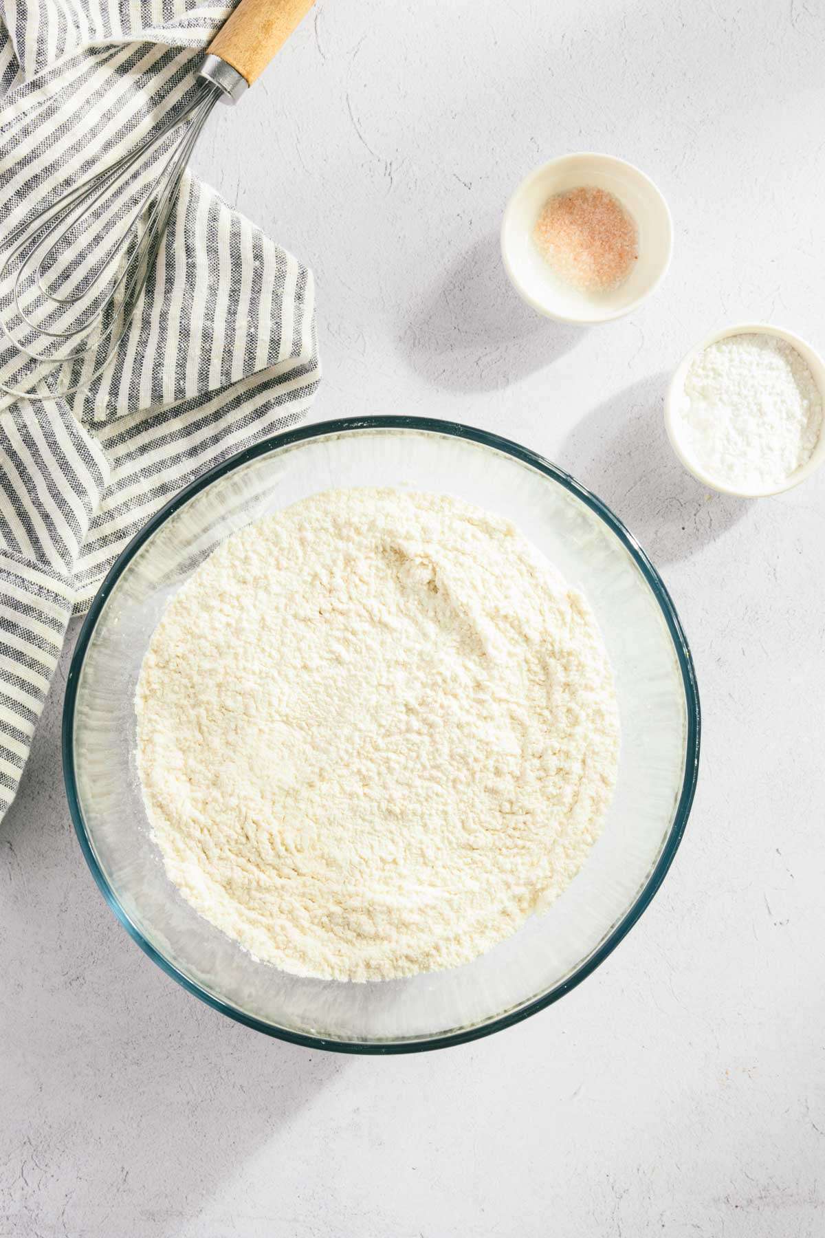 glass bowl with flour, small dish with salt and baking powder