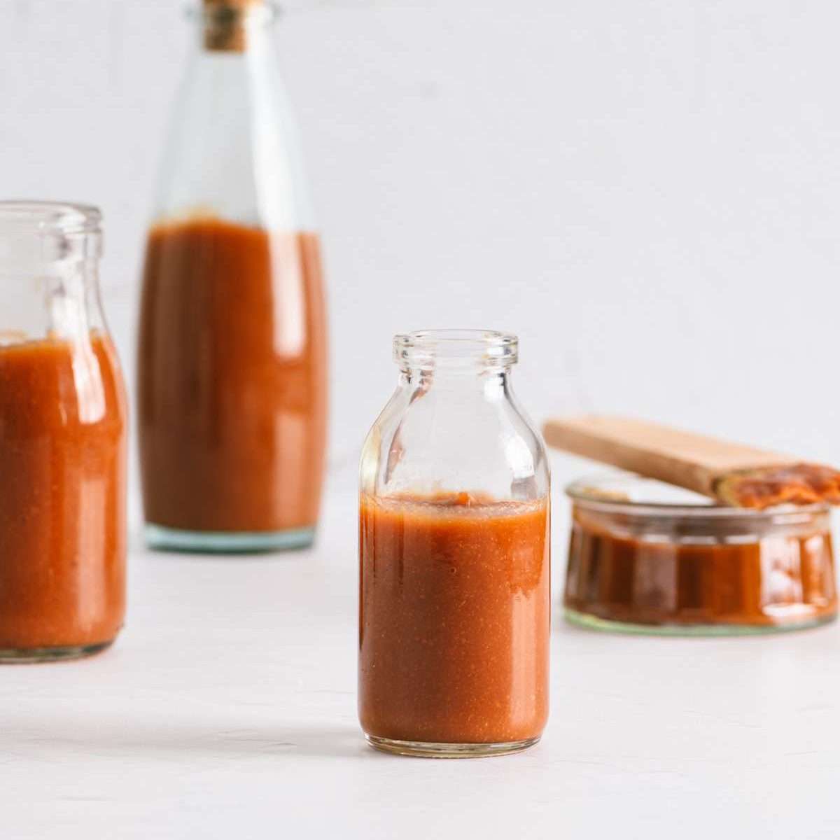 Peach BBQ Sauce in various bottles, straight on view