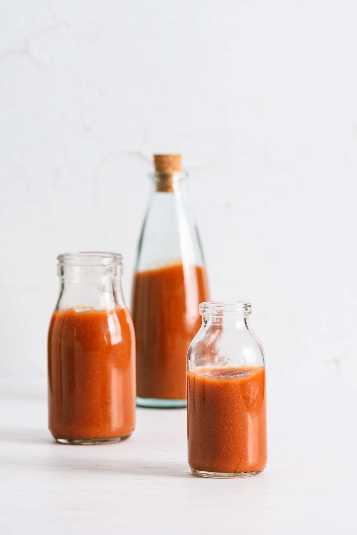 Peach BBQ Sauce in various bottles, straight on view