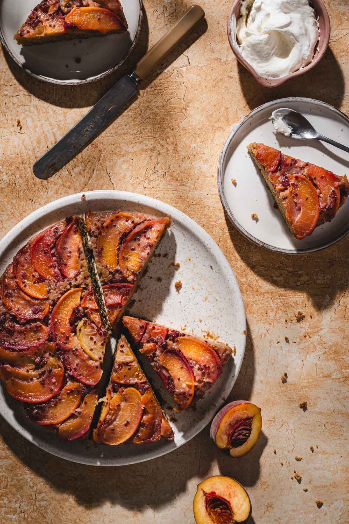 peach cake on a serving plate, slices, knife