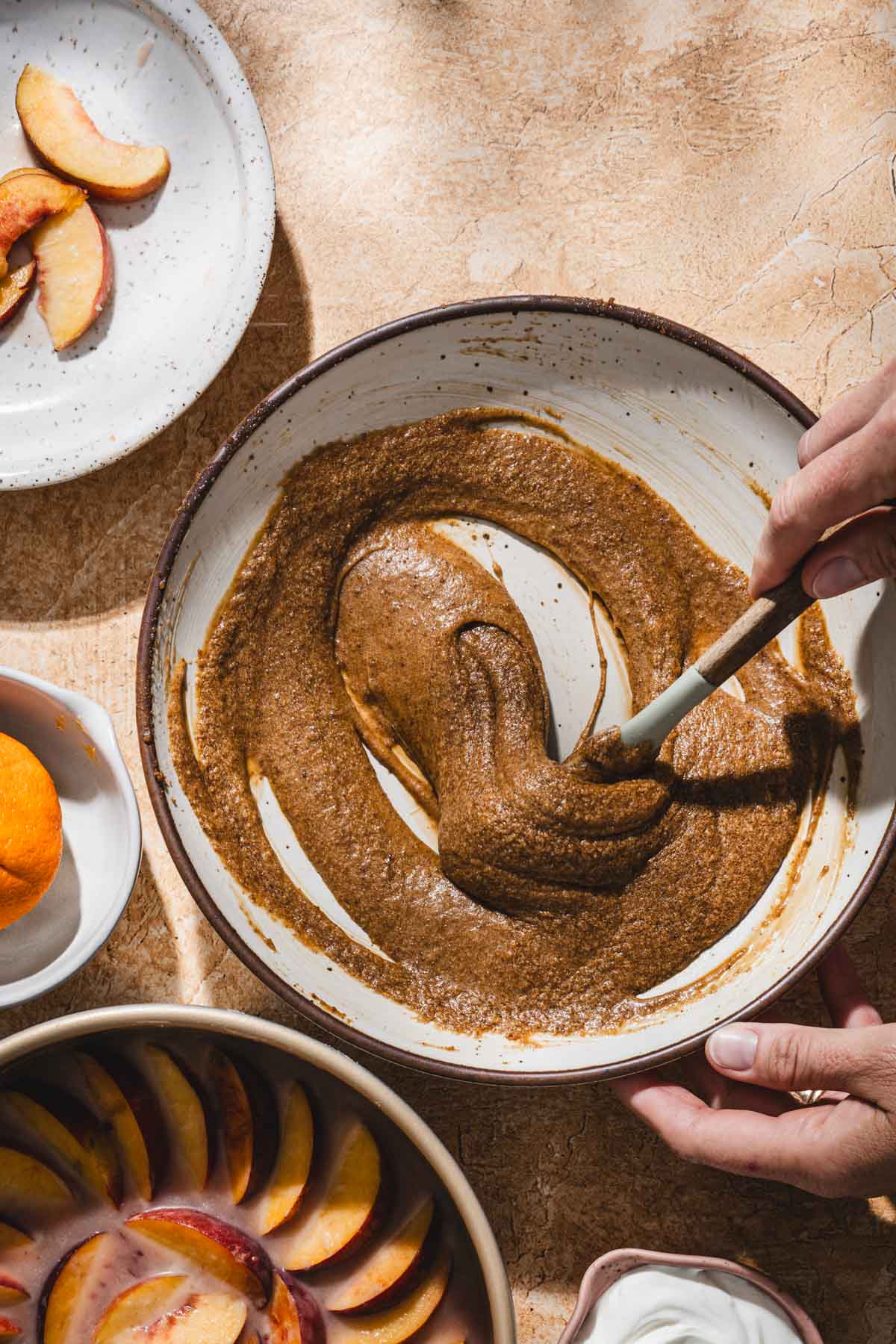hands in frame stirring wet ingredients