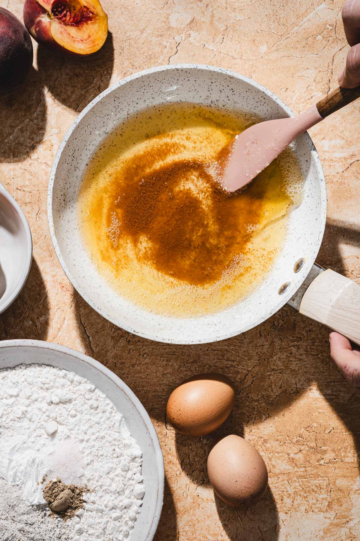 hands in frame stirrin brown butter