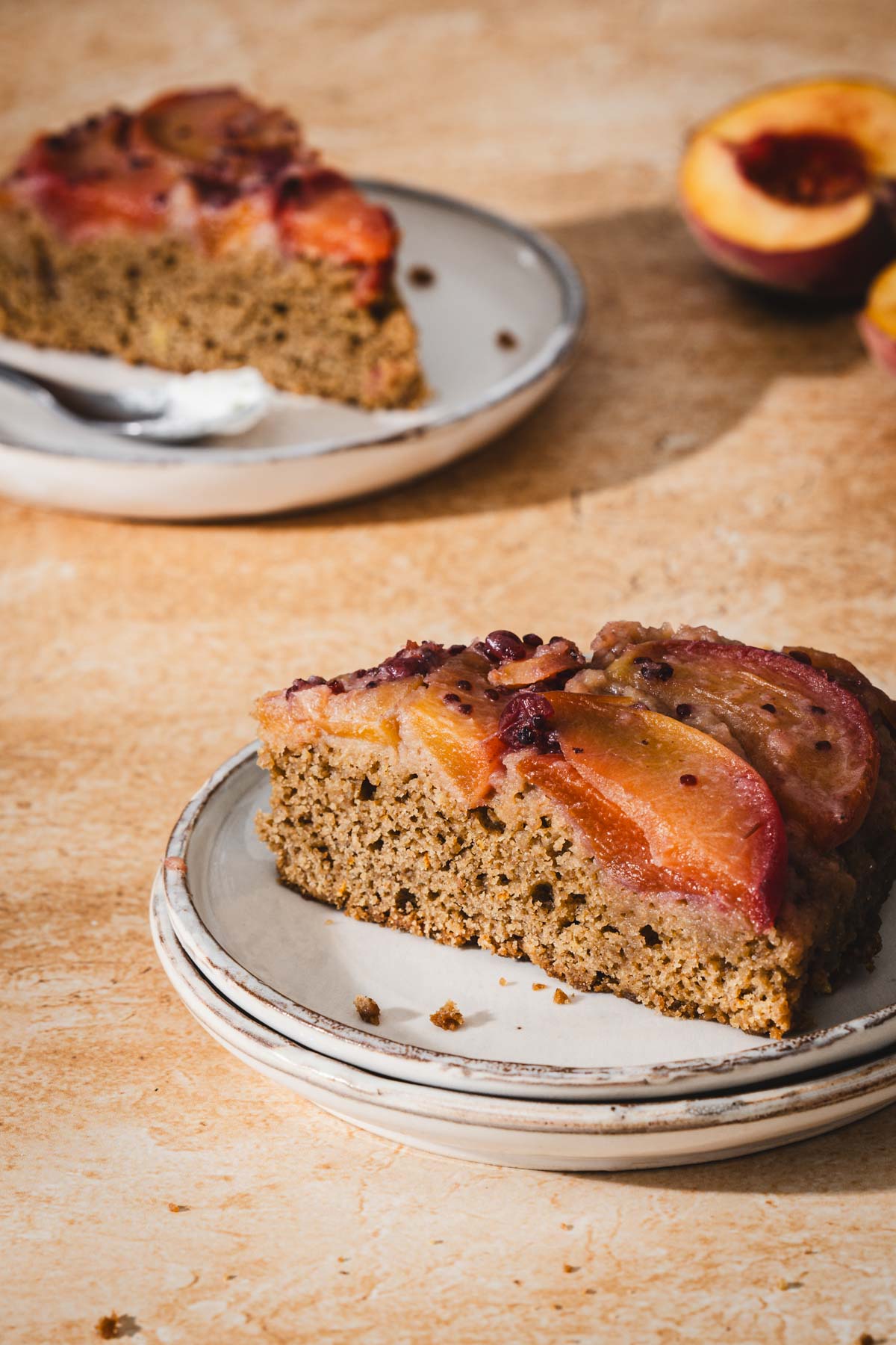 single slices of peach cake on serving plates