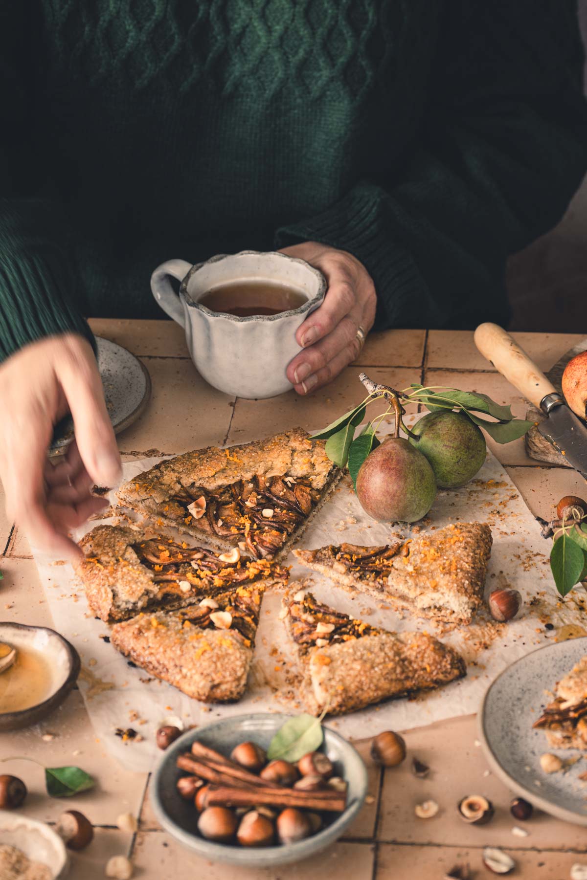 hand in frame reaching for a slice of galette
