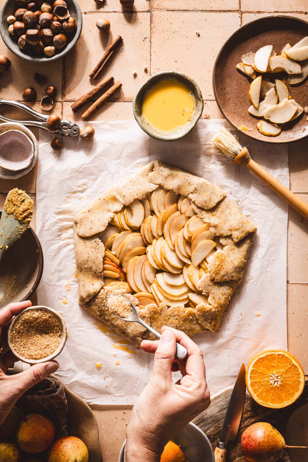 hands in frame applying sugar