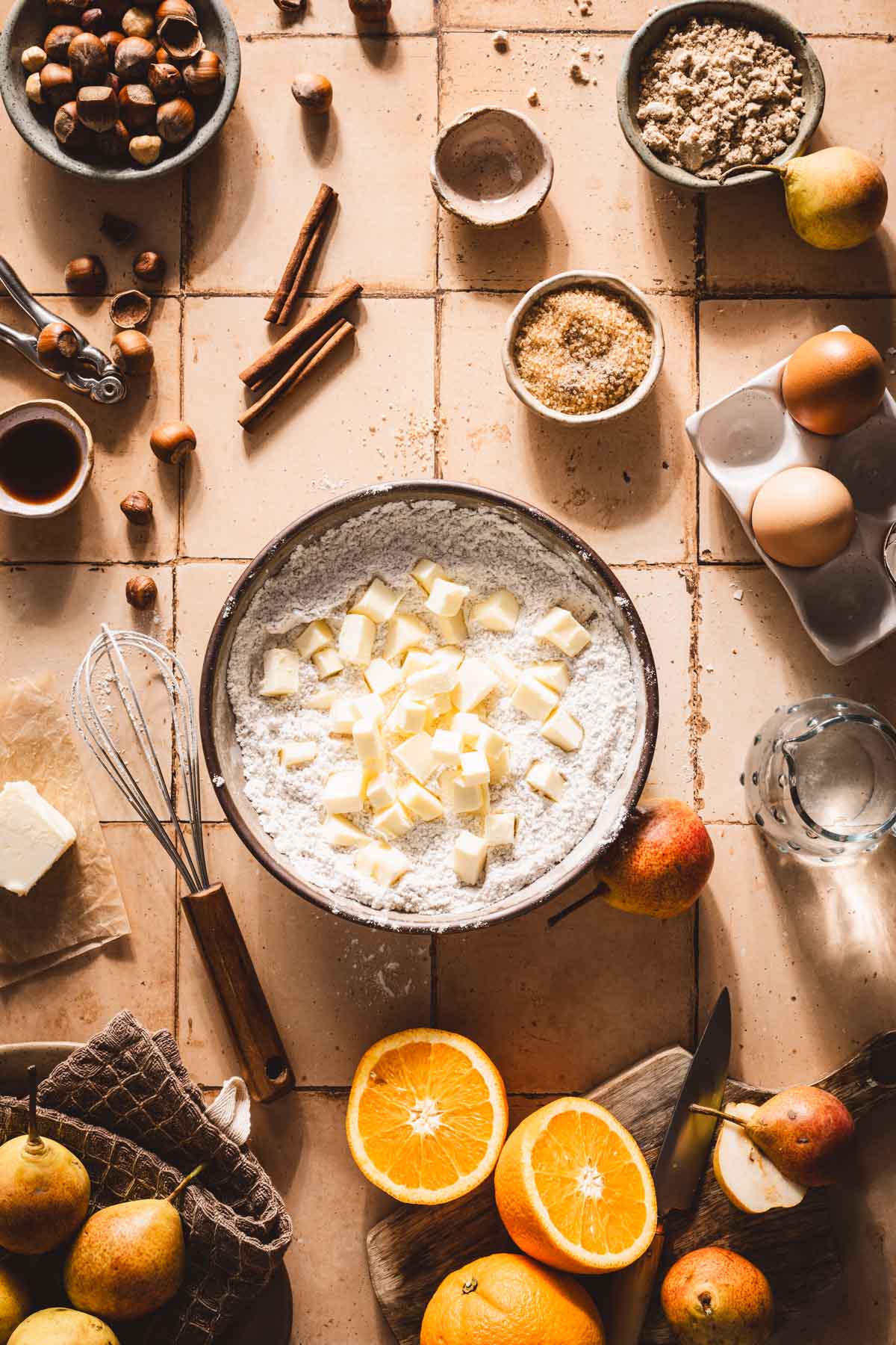 cubbed butter added to the bowl with flour