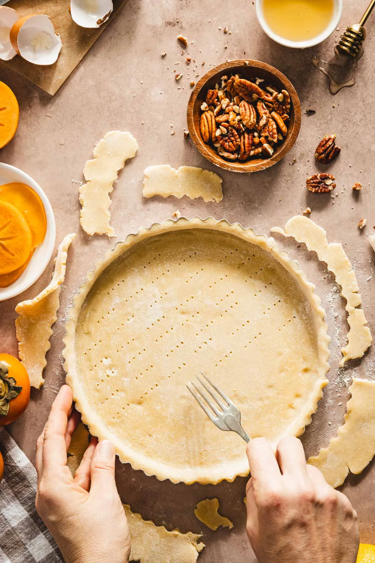 hands in frame holding fork making tiny holes in the raw dough