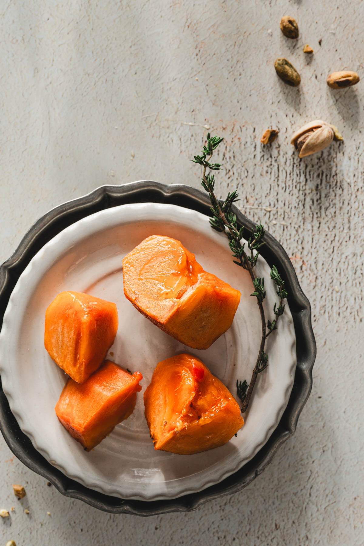 small plate with cut up persimmon pieces