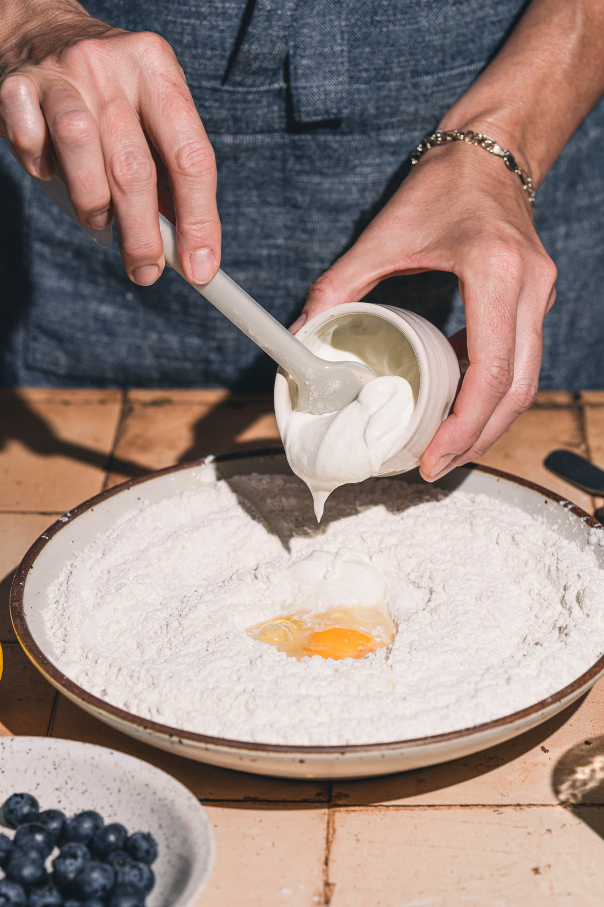 hands in frame holding a dish with sour cream