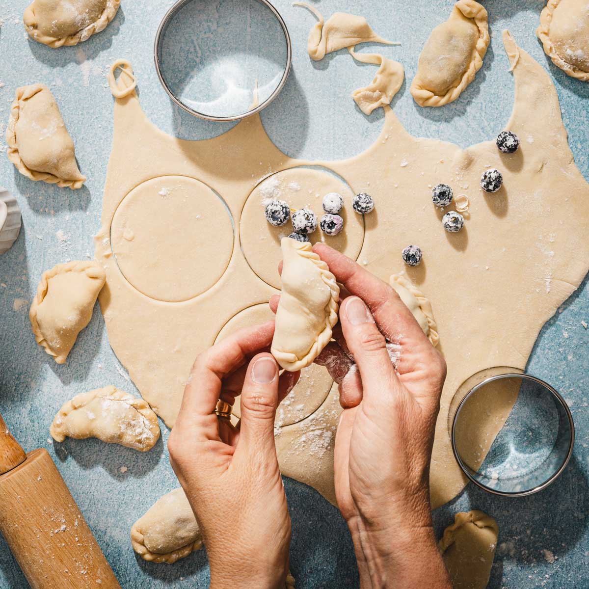 hands in frame holding pierogi