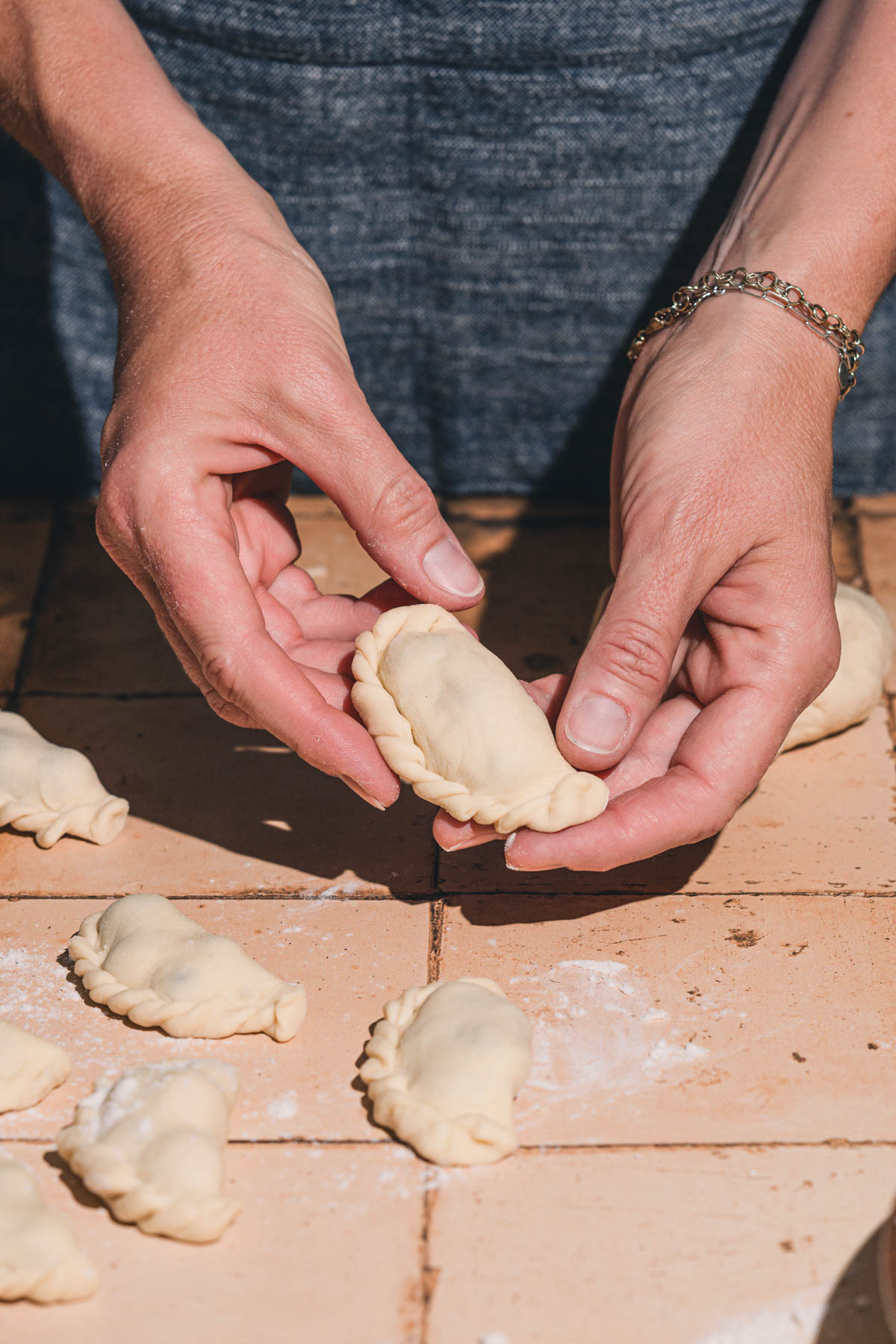 hands in frame holding pierogi