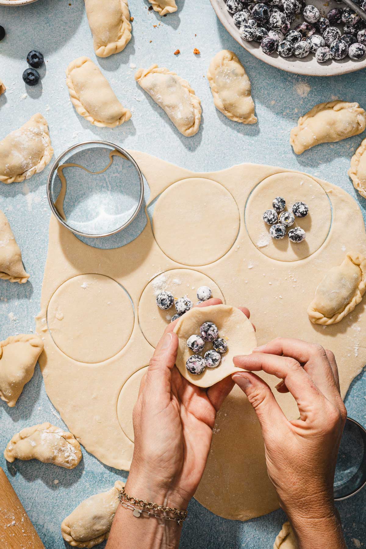 hands in frame folding pierogi