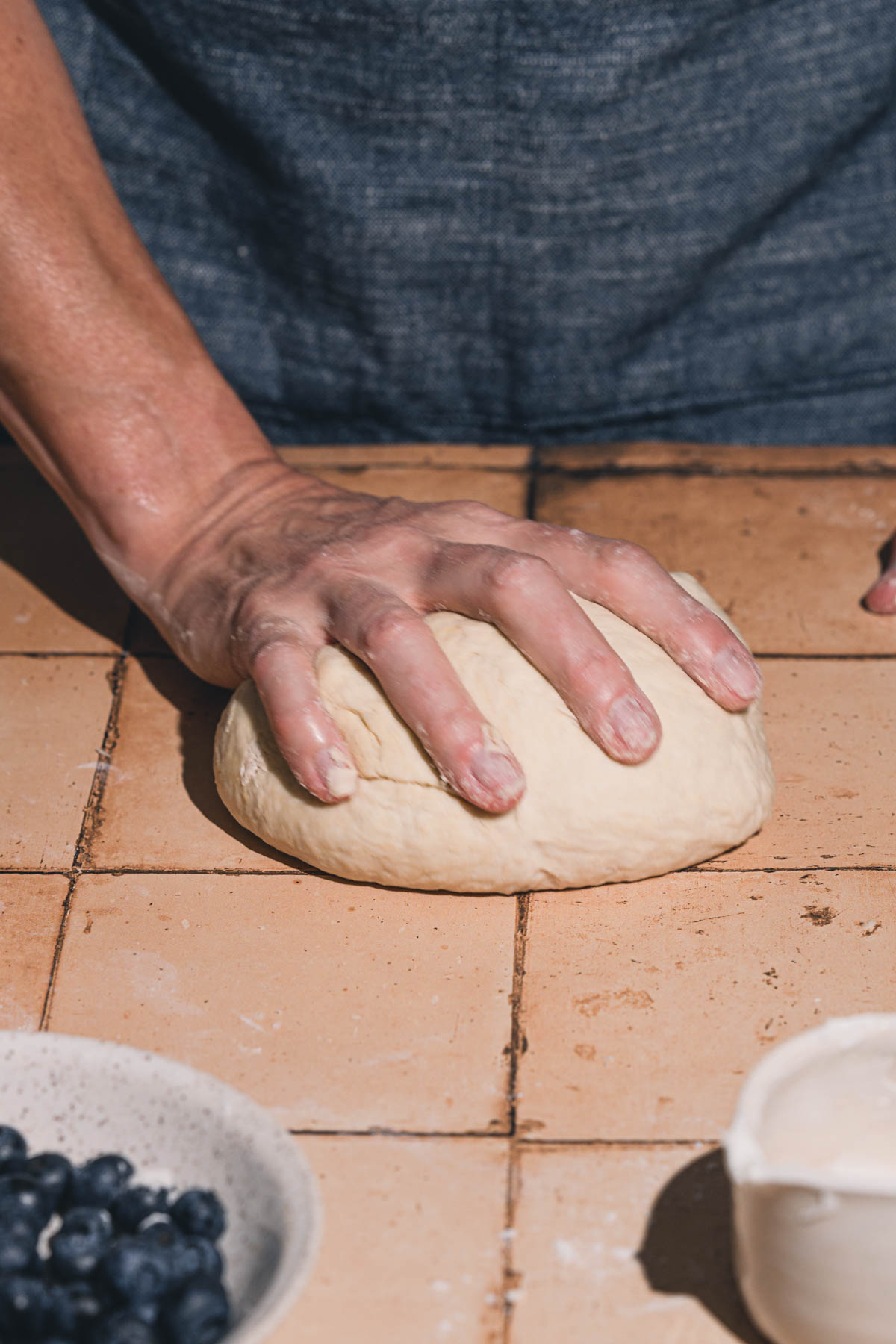 hands in frame over formed dough
