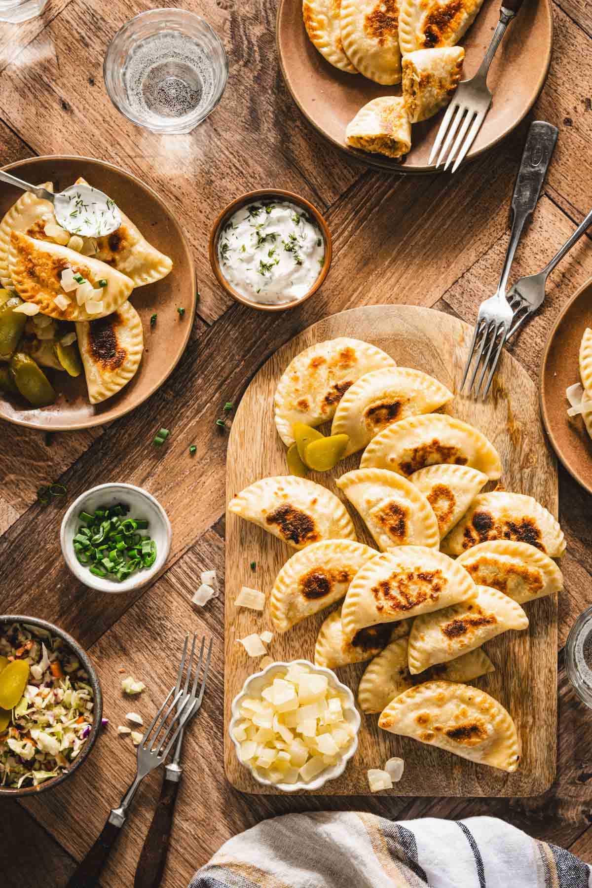 pan fried pierogis on a serving wooden board
