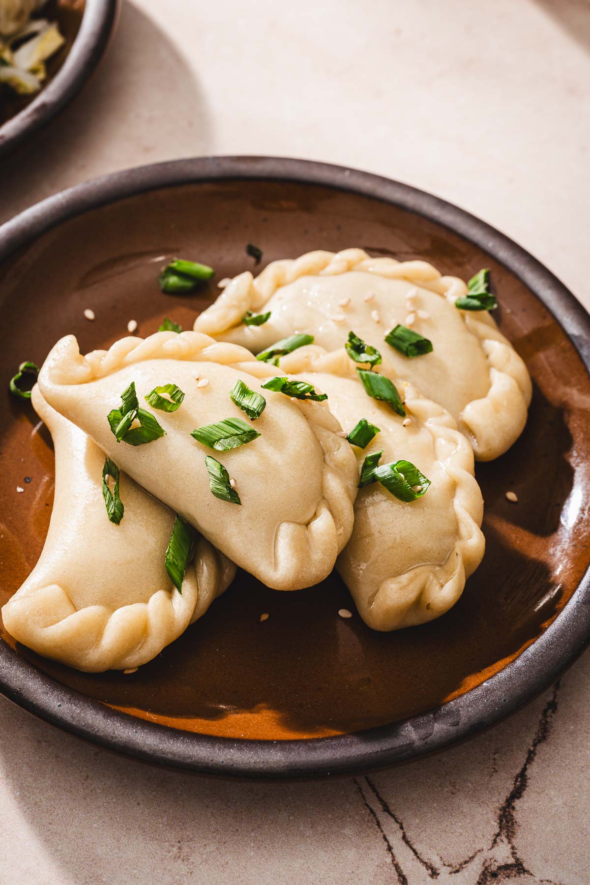 close up of a plate with pierogi