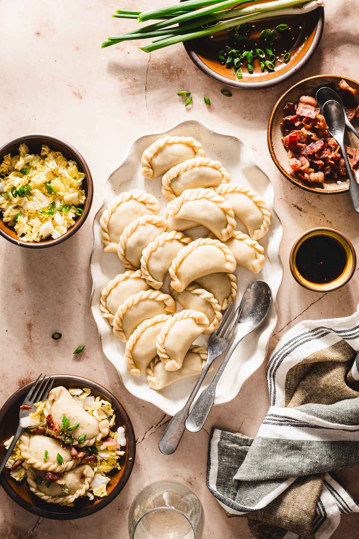 cookd pierogi on a plattr, other small plats with side dishs