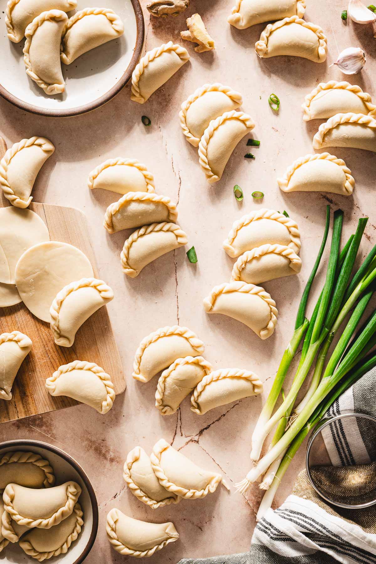 mad, raw pierogi, fresh green onions,