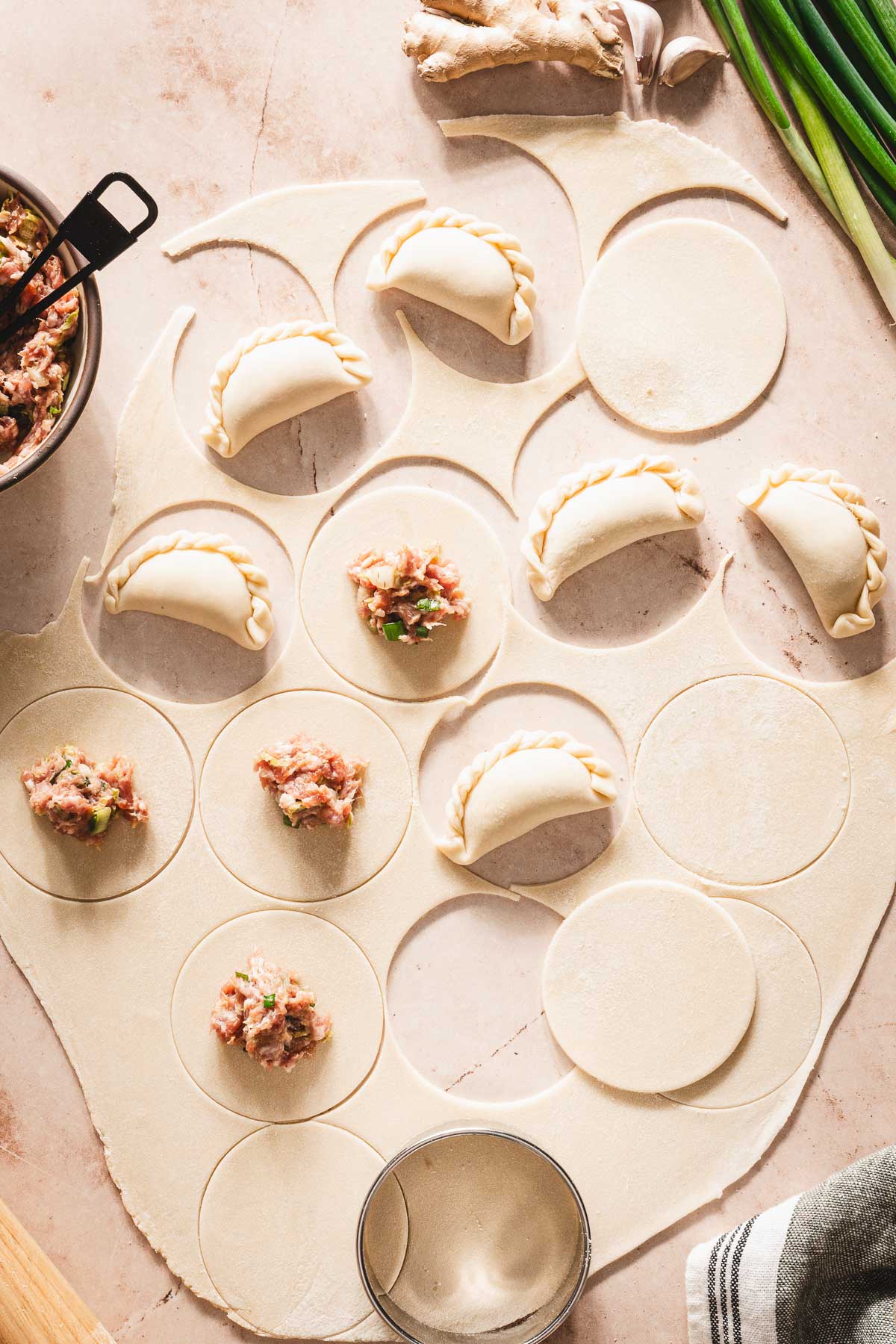 dough rolled out, some pierogi formed with th filling