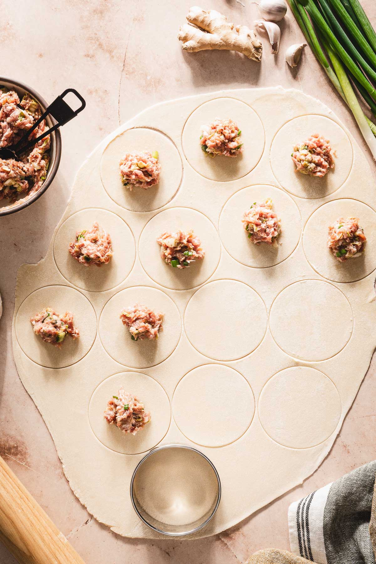 dough rolled out, circles cut out, some filling on the dough