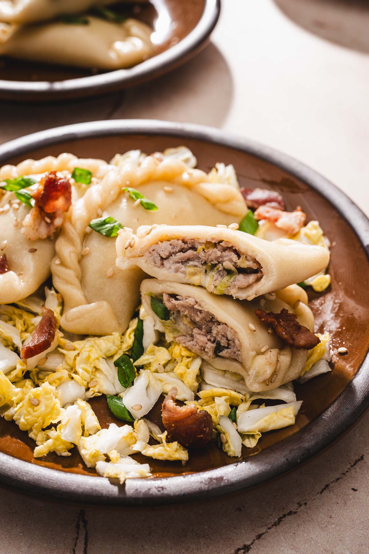 close up of a plate with pierogi, one cut up open