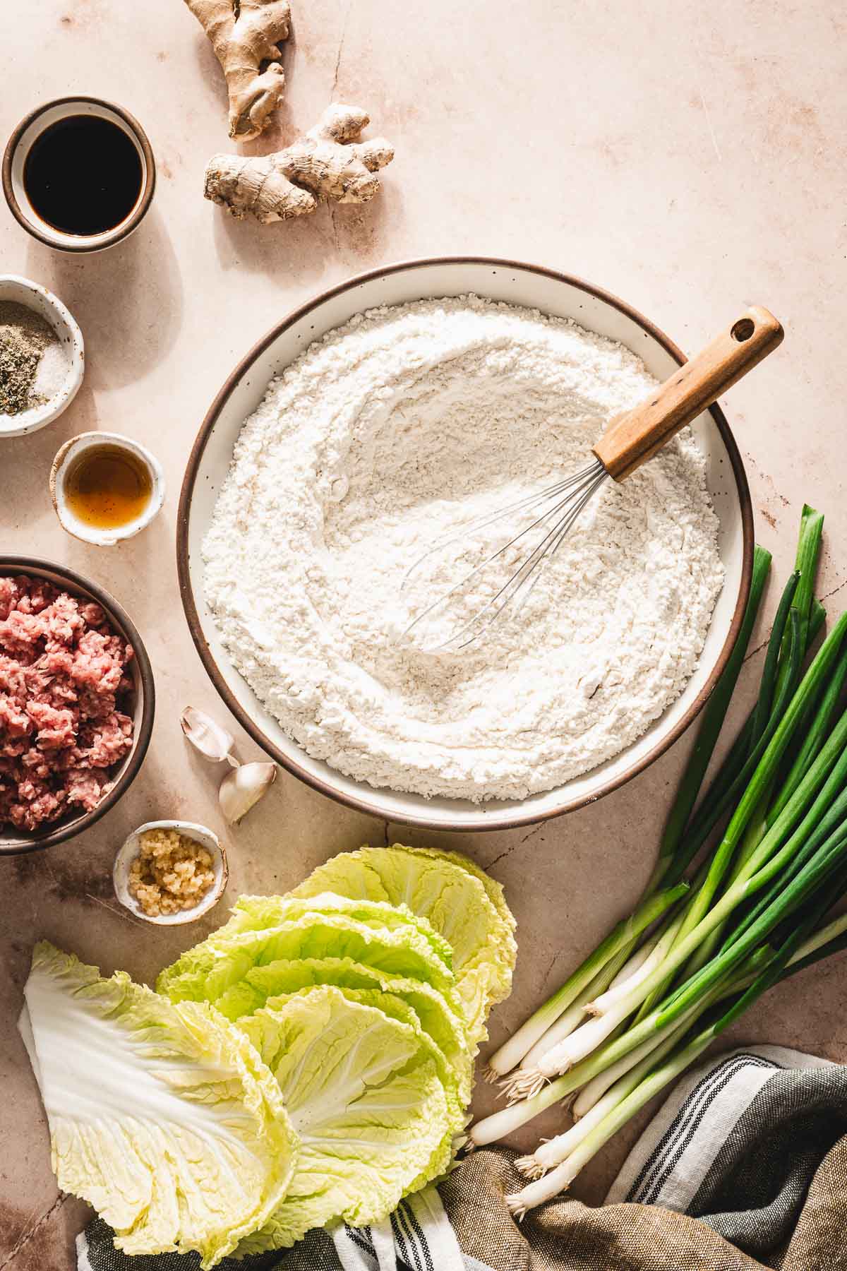 large bowl with flour, othr ing around