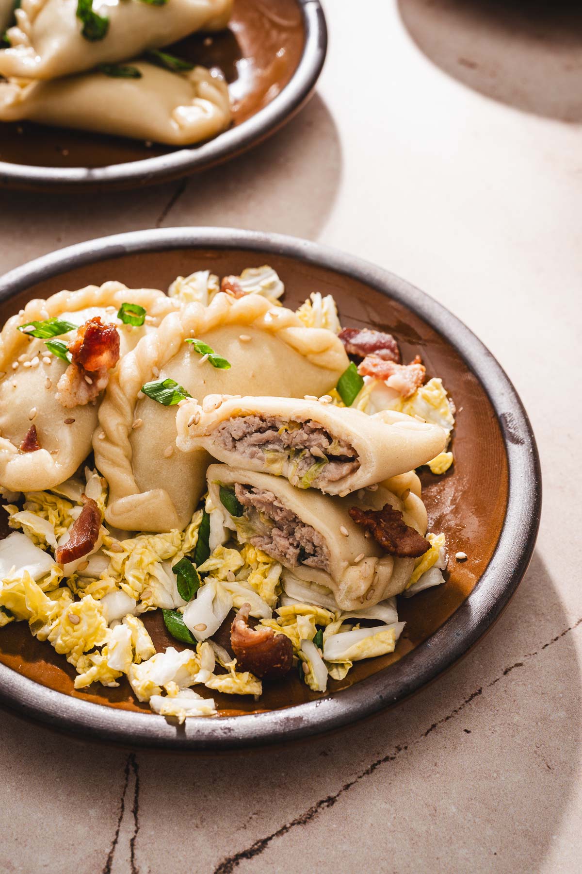 close up of a plate with pierogi, one cut up open