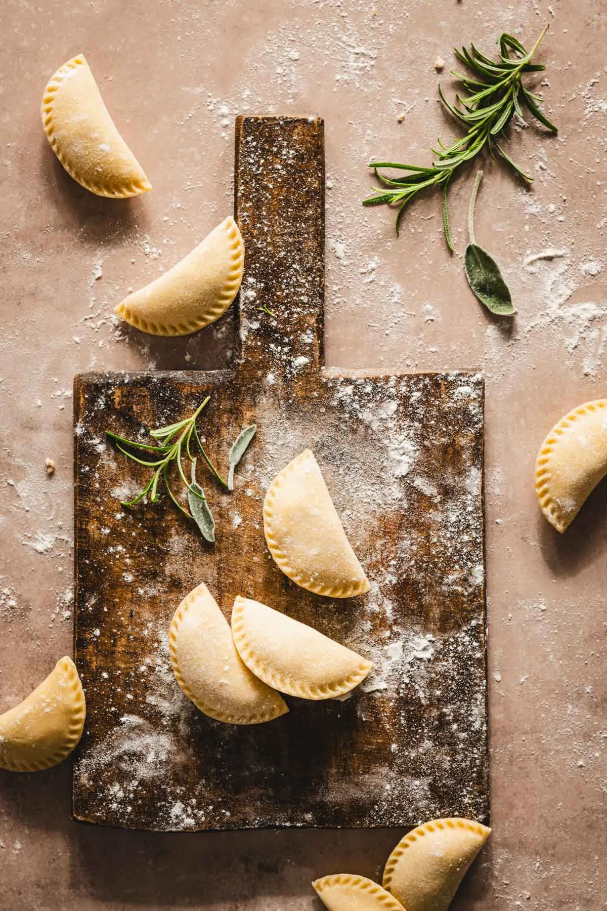 finished pierogis on a wooden cutting board
