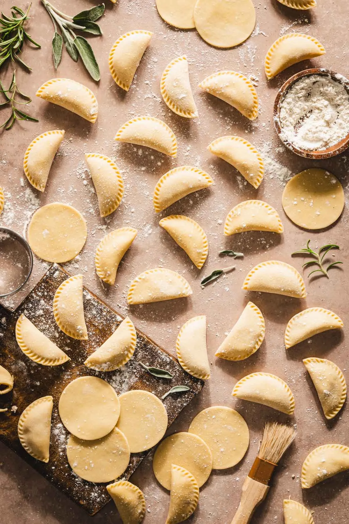 formed pierogis, cutting board with pierogi dough